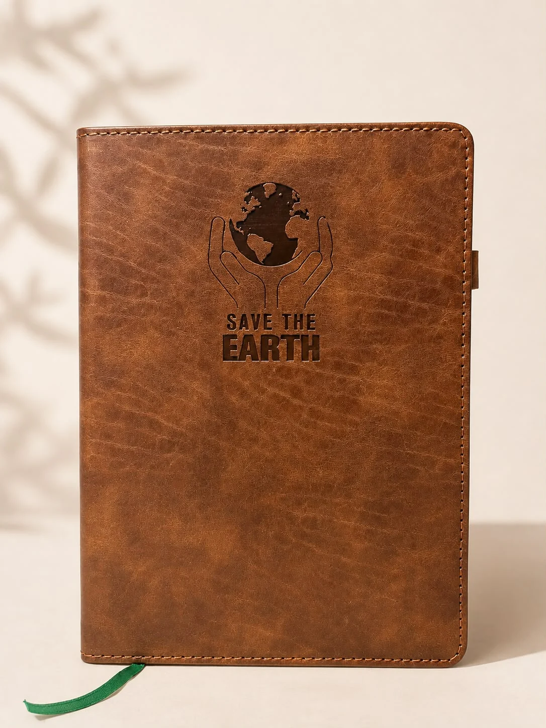 Tan leather diary with a debossed emblem